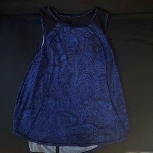Deep blue lululemon tank top with black sheer details, open back & floral print.